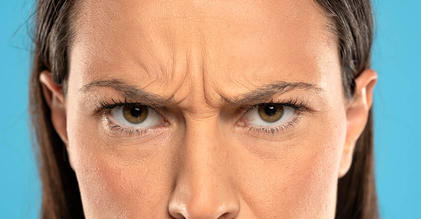 Pionowe zmarszczki na czole u młodej kobiety